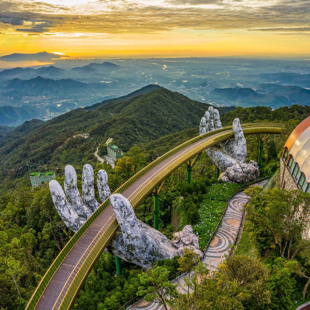 Aerial view of the famous Golden Bridge (Cầu Vàng) held by giant stone hands at Ba Na Hills, a popular day trip tourist attraction from Da Nang.